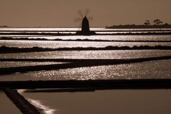 Windmill over salt lakes at sunset